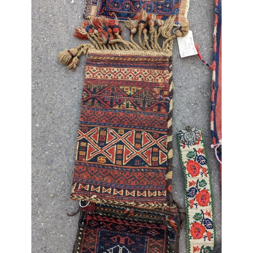 1126 - An Afghan Kilim flatweave saddlebag, 144 x 69cm together with six assorted bags, faces, etc.... 