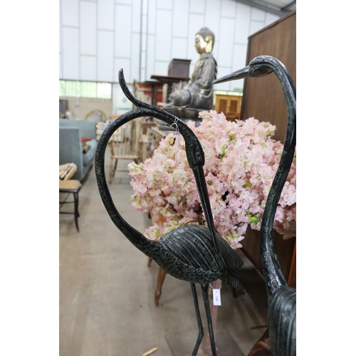 1135 - A pair of bronzed metal crane garden ornaments, larger height 136cm