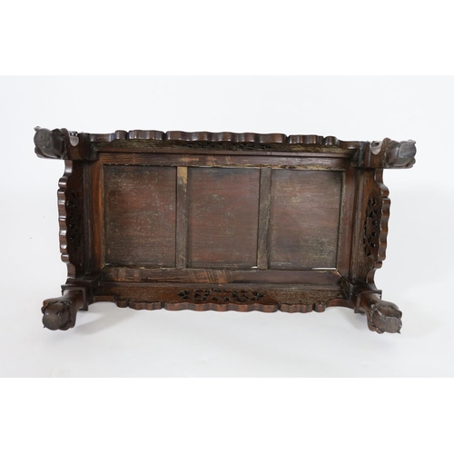 1185 - A Chinese hongmu Kang table, 19th century,the panelled rectangular top above a fruiting vine carved ... 