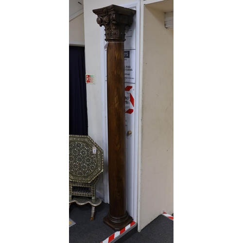 1202 - A pair of carved oak Corinthian columns, height 200cm