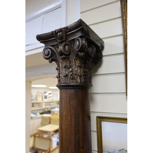 1202 - A pair of carved oak Corinthian columns, height 200cm