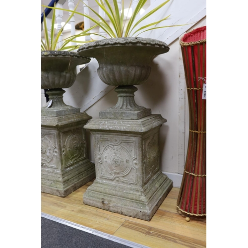 1206 - A pair of reconstituted stone campana garden urns on square plinth bases, height 90cm