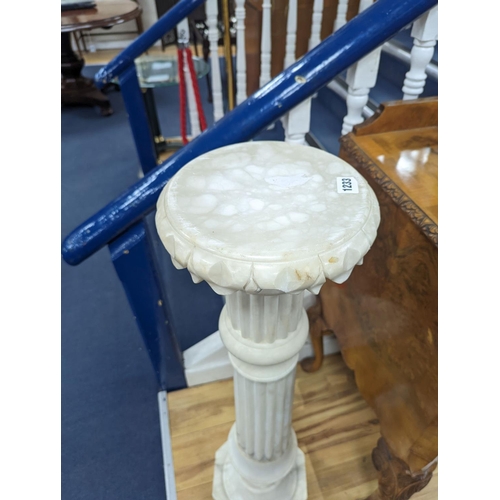 1208 - A carved alabaster pedestal on octagonal base, height 108cm