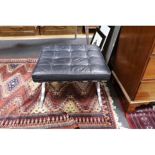 1211 - A Barcelona style black leather and chrome footstool, length 64cm, depth 57cm, height 37cm... 