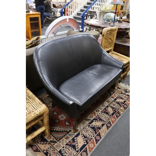 1216 - A mid century design black leather tub framed settee, length 136cm, depth 76cm, height 89cm... 