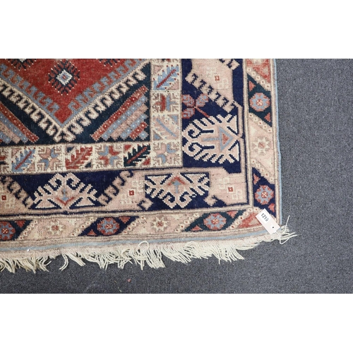 1219 - A Caucasian red ground rug and a Bokhara runner, rug 180 x 120 cms