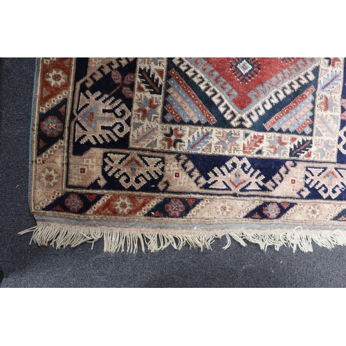 1219 - A Caucasian red ground rug and a Bokhara runner, rug 180 x 120 cms