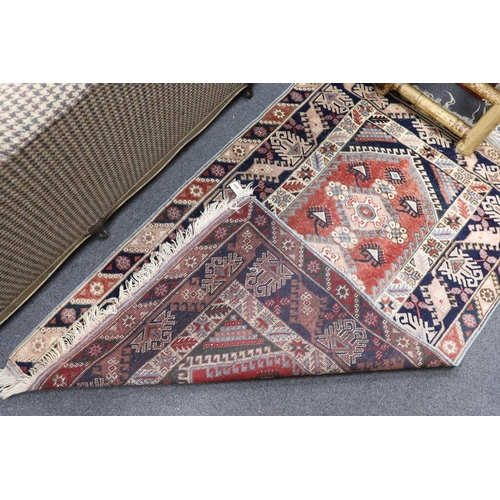 1219 - A Caucasian red ground rug and a Bokhara runner, rug 180 x 120 cms