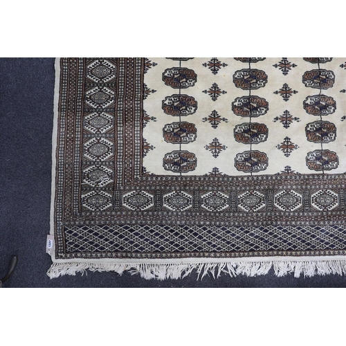 1227 - A Bokhara ivory ground rug, 246 x 156cm