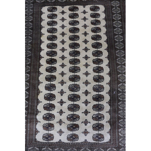 1227 - A Bokhara ivory ground rug, 246 x 156cm