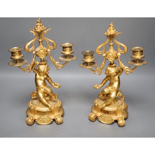 1294 - A pair of Louis XVI style ormolu cherub candelabra, late 19th century,  31cm