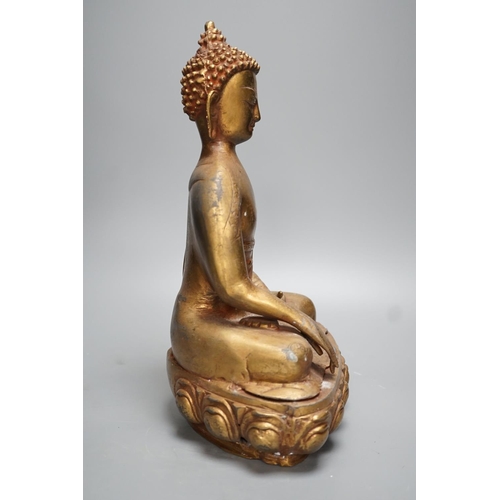 1311 - A gilt brass seated figure of Buddha - 38cm high