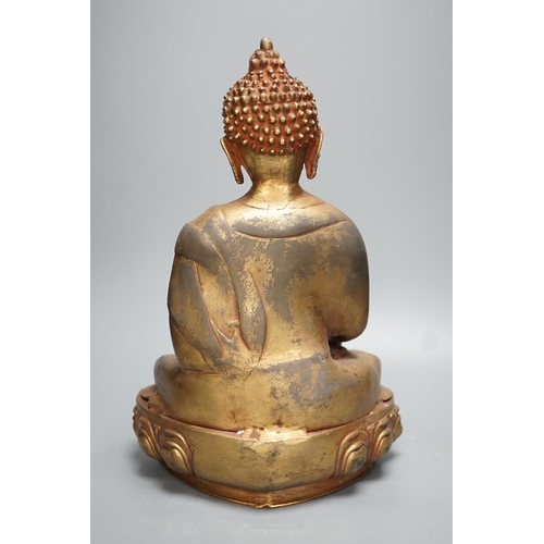 1311 - A gilt brass seated figure of Buddha - 38cm high