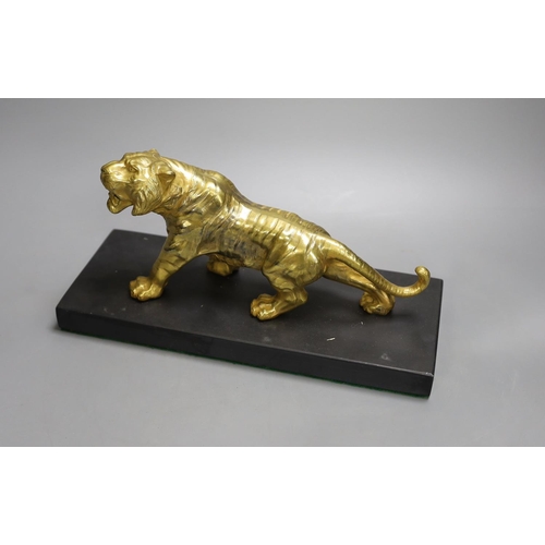 1368 - A gilt bronze figure of a tiger on base - 13cm tall