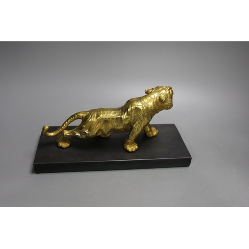 1368 - A gilt bronze figure of a tiger on base - 13cm tall