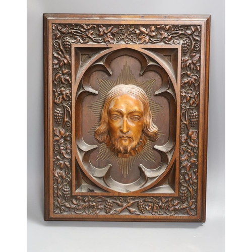 1373 - A late 19th century Continental heavily carved walnut and boxwood panel of Christ, a pair of brass l... 