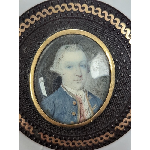 1557 - A 19th century pressed bois durci and gilt metal snuff box with painted miniature portrait of a gent... 