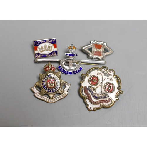 1558 - Four military badges: A Royal Navy badge and ski club badge, South Africa badge and another.... 