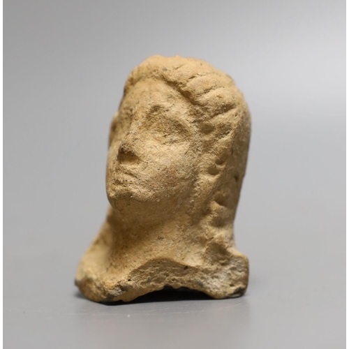 1560 - An antiquity terracotta figure head,8cms high.