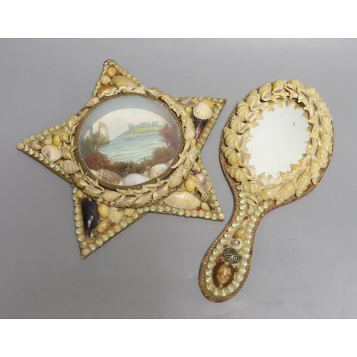 1562 - A shell mounted star with central scenic seascape and a shell hand mirror, star 24 cms wide.... 