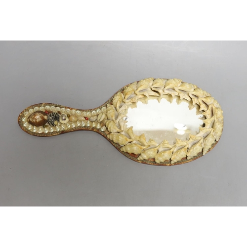 1562 - A shell mounted star with central scenic seascape and a shell hand mirror, star 24 cms wide.... 