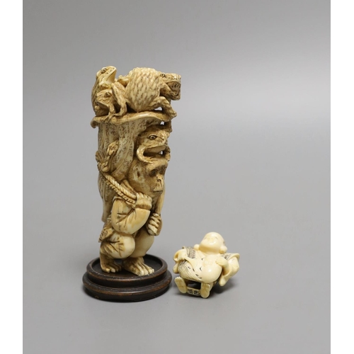 1587 - A Japanese ivory okimono of a monkey carrying a lotus leaf containing toads, on its back and an Ivor... 