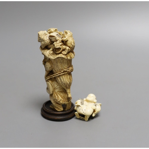 1587 - A Japanese ivory okimono of a monkey carrying a lotus leaf containing toads, on its back and an Ivor... 