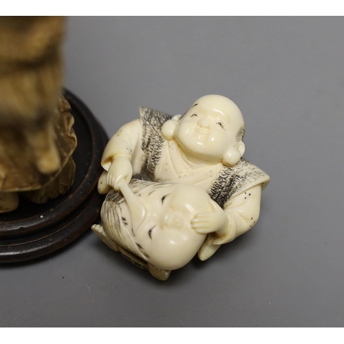 1587 - A Japanese ivory okimono of a monkey carrying a lotus leaf containing toads, on its back and an Ivor... 