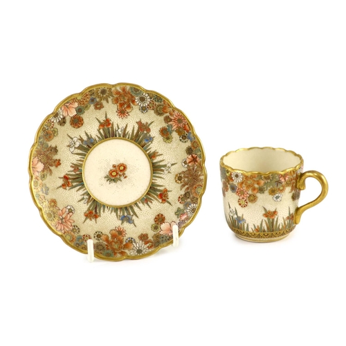 1594 - A Japanese Satsuma pottery cup and saucer, signed Seikozan, Meiji period,painted with flowers and fo... 