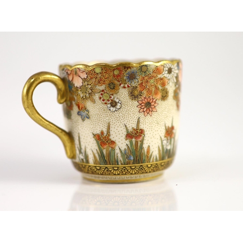 1594 - A Japanese Satsuma pottery cup and saucer, signed Seikozan, Meiji period,painted with flowers and fo... 