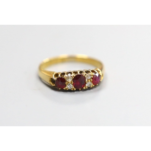 1953 - A late Victorian 18ct gold, three stone ruby and four stone diamond set half hoop ring, size M, gros... 