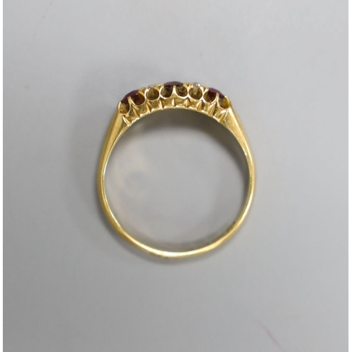 1953 - A late Victorian 18ct gold, three stone ruby and four stone diamond set half hoop ring, size M, gros... 