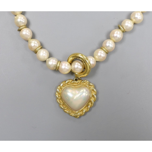 1956 - A 1960's single strand cultured pearl necklace, with an 18ct gold and mother of pearl set heart shap... 