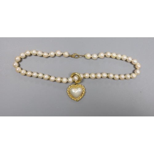 1956 - A 1960's single strand cultured pearl necklace, with an 18ct gold and mother of pearl set heart shap... 