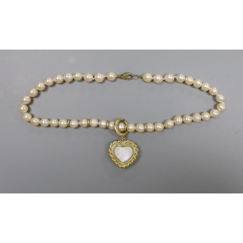 1956 - A 1960's single strand cultured pearl necklace, with an 18ct gold and mother of pearl set heart shap... 