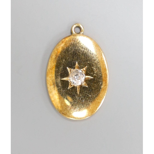 1960 - A yellow metal and single stone diamond set oval pendant, 19mm, gross 3 grams.