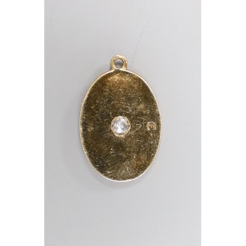 1960 - A yellow metal and single stone diamond set oval pendant, 19mm, gross 3 grams.