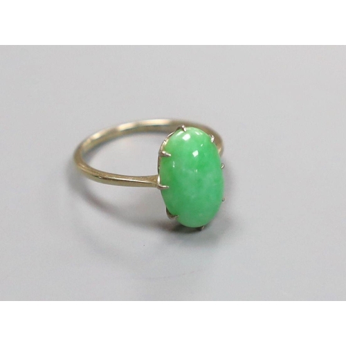 1961 - A white metal and oval cabochon jade set ring, size L, gross 2.4 grams.