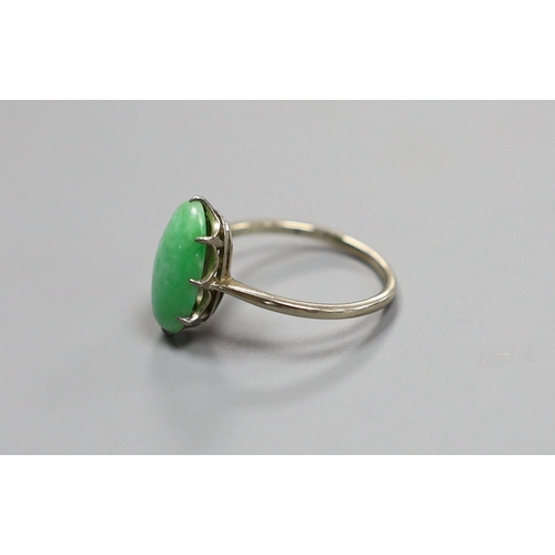 1961 - A white metal and oval cabochon jade set ring, size L, gross 2.4 grams.