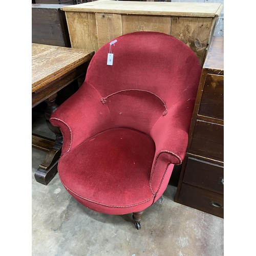 36 - A late Victorian nursing chair upholstered in red dralon, width 78cm, depth 80cm, height 92cm... 