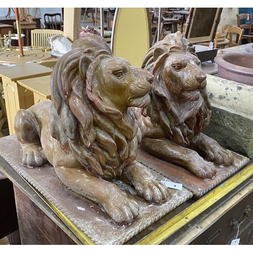 4 - A pair of faux terracotta resin recumbent lion garden ornaments, length 74cm, width 36cm, height 50c... 