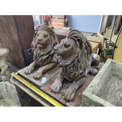 4 - A pair of faux terracotta resin recumbent lion garden ornaments, length 74cm, width 36cm, height 50c... 