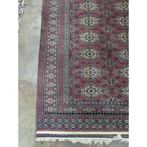 42 - A Tekke Bokhara red ground rug, woven with rows of elephant feet, 180 x 126cm