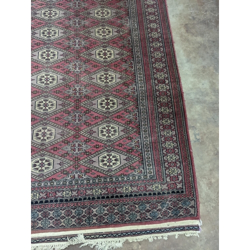 42 - A Tekke Bokhara red ground rug, woven with rows of elephant feet, 180 x 126cm