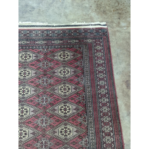 42 - A Tekke Bokhara red ground rug, woven with rows of elephant feet, 180 x 126cm