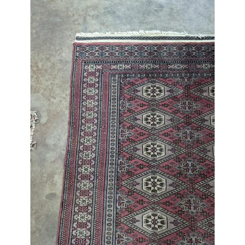 42 - A Tekke Bokhara red ground rug, woven with rows of elephant feet, 180 x 126cm