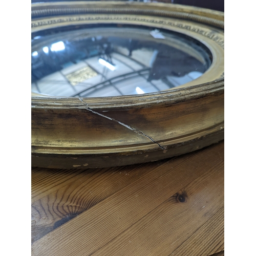 1142 - A large Regency circular giltwood and gesso convex wall mirror, diameter 86cm