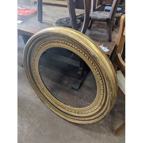 1142 - A large Regency circular giltwood and gesso convex wall mirror, diameter 86cm