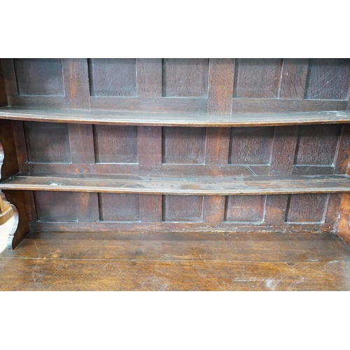 10 - An 18th century oak dresser with boarded rack, width 150cm, depth 47cm, height 196cm