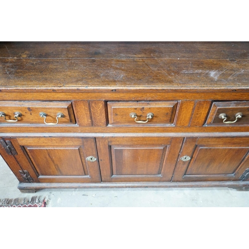 10 - An 18th century oak dresser with boarded rack, width 150cm, depth 47cm, height 196cm